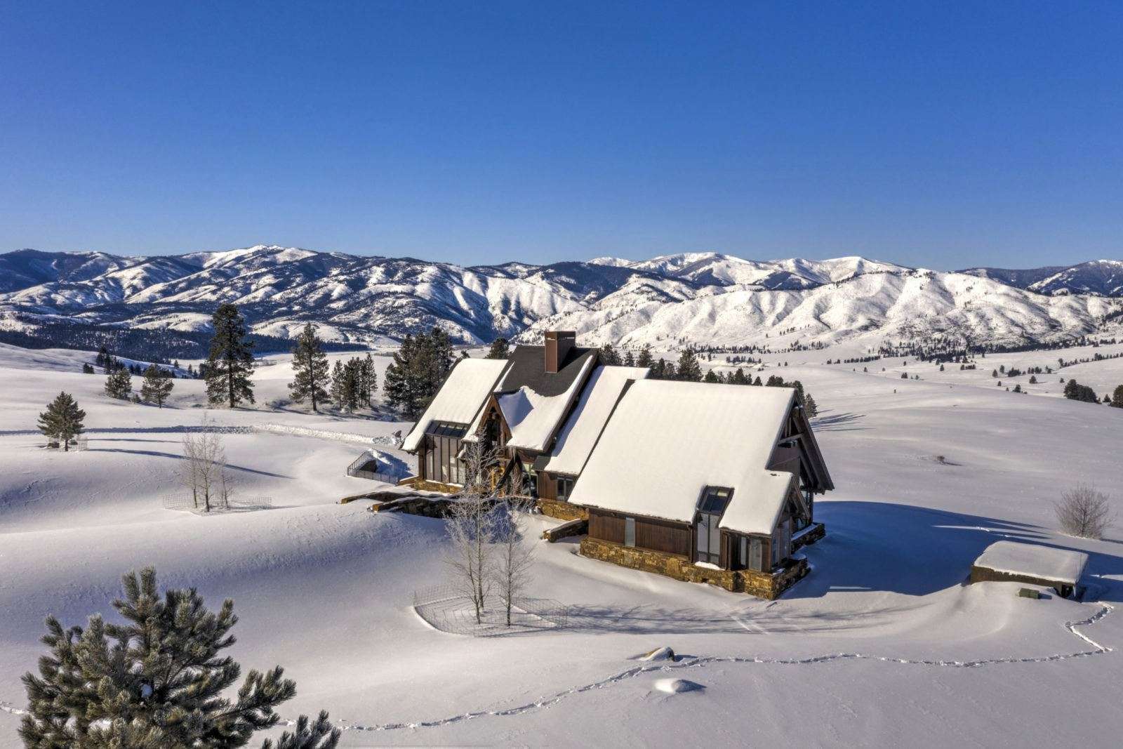 Snow covered luxury ranch house in the mountains in Montana