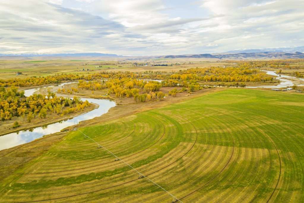 Pivot on farmland next to a winding river on a Montana ranch for sale