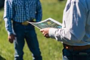 Western Ranch Brokers team looking at a map of a Montana ranch for sale