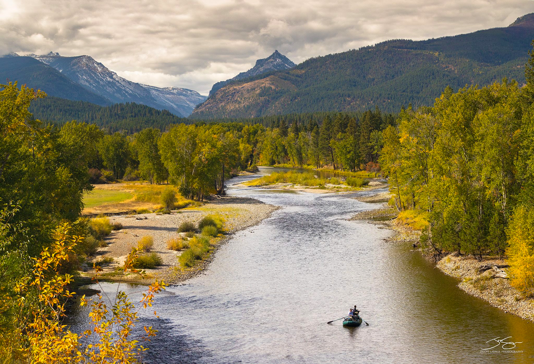 Kayaker on the Bitterroot River in Montana surrounded by mountains
